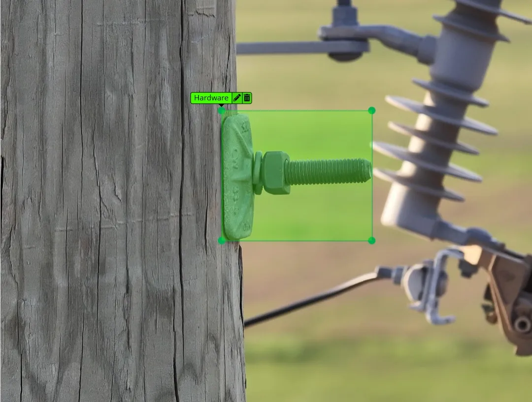 AI detection box labeled Hardware highlighting a bolt and washer on a wooden pole next to an insulator